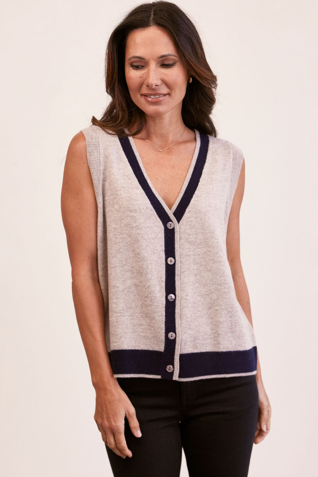 woman wearing 100% Luxe Merino Buttun Front Vest - Natural/Navy and black pants