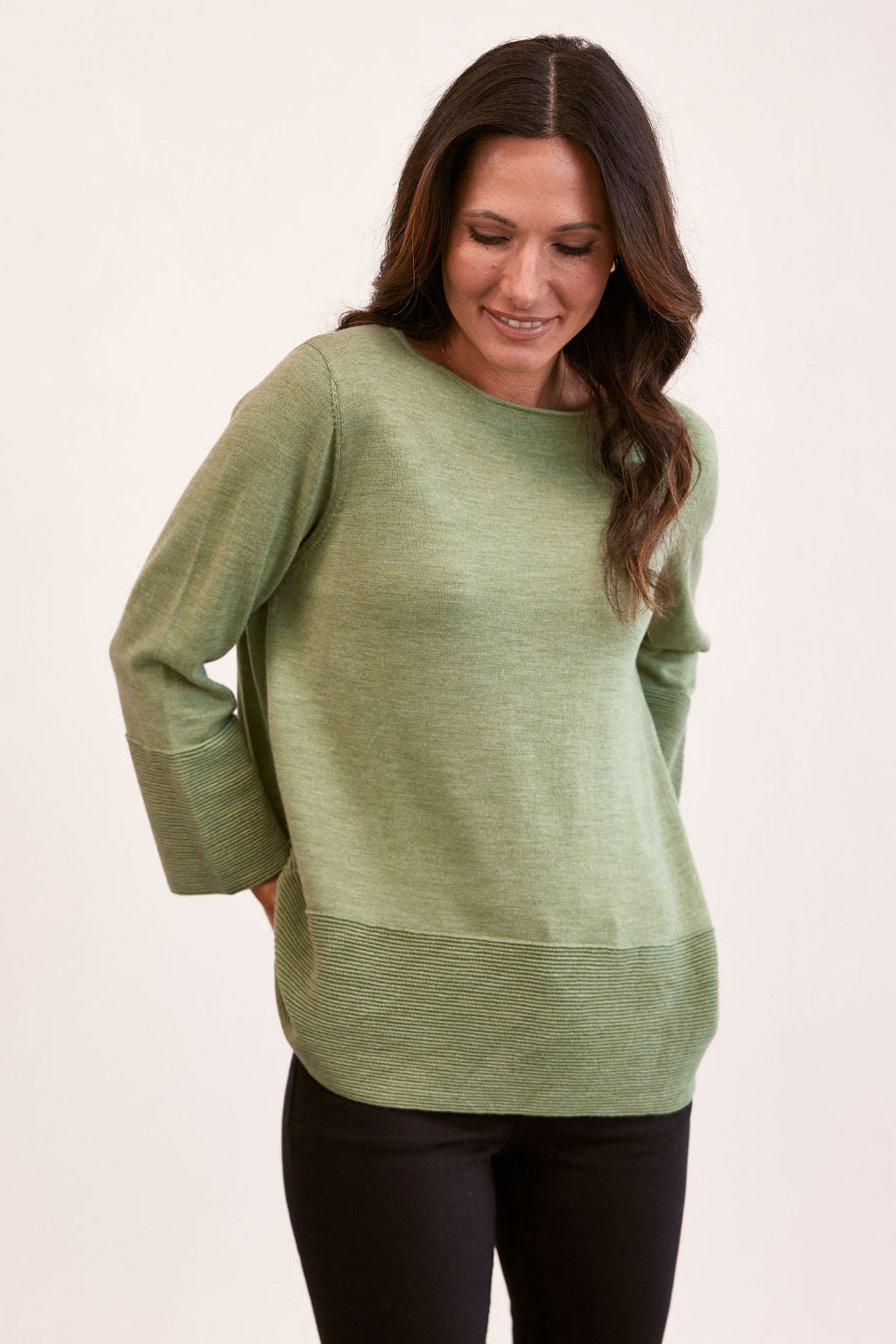 woman wearing 100% Merino  7/8 Rib Sleeve  - Sage and black pants
