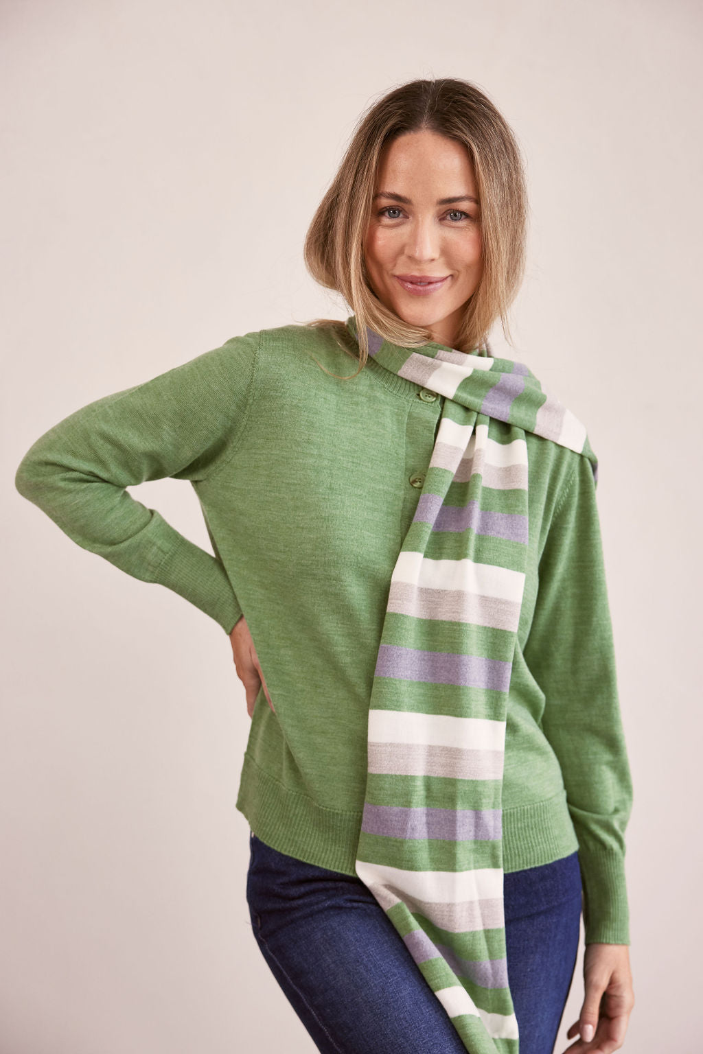 woman wearing Merino Wool Stripe Scarf Sage Combo and dark denim pants
