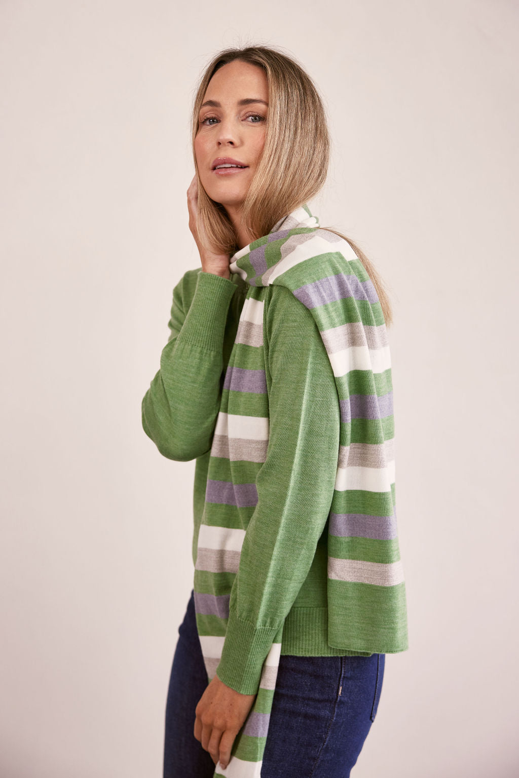 woman wearing Merino Wool Stripe Scarf Sage Combo and dark denim pants