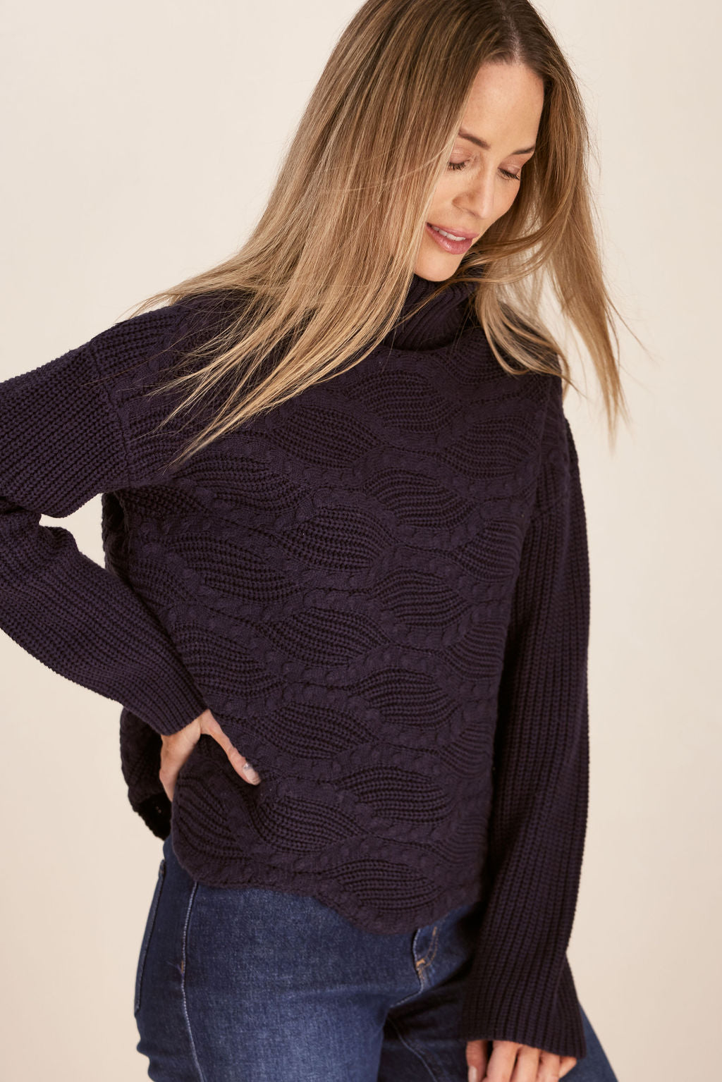 Woman wearing Wave Knit Sweater -Navy and dark denim pants