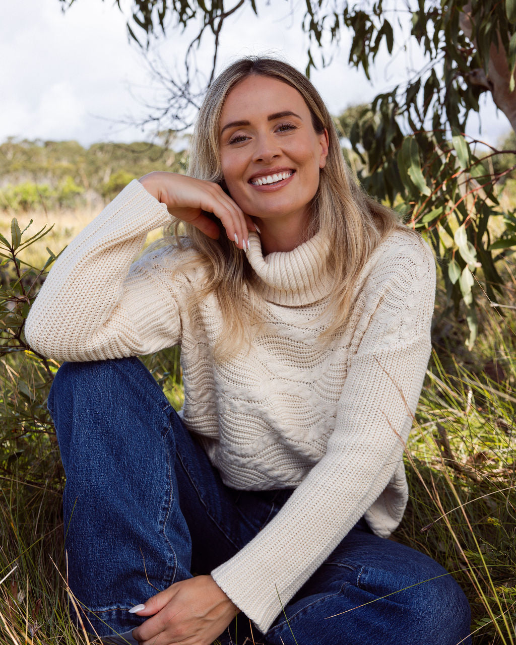 Woman wearing Wave Knit Sweater -Vanilla and dark denim pants