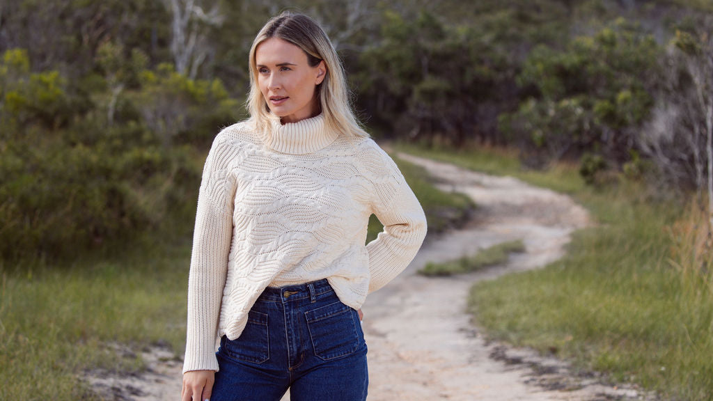 Woman wearing Wave Knit Sweater -Vanilla and dark denim pants