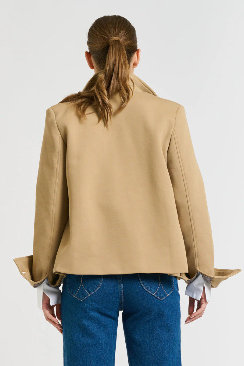 Woman facing the back wearing blue denim pants and Hemming Scuba Jacket - Caramel