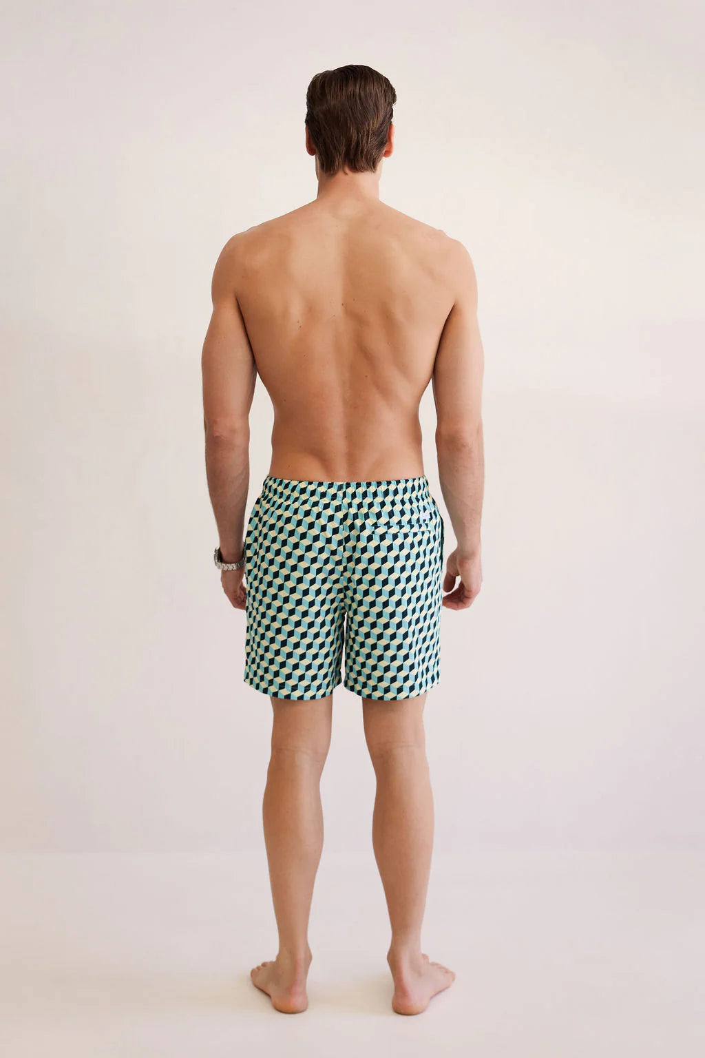 man facing the back wearing shore club swim means swim short in poolside design